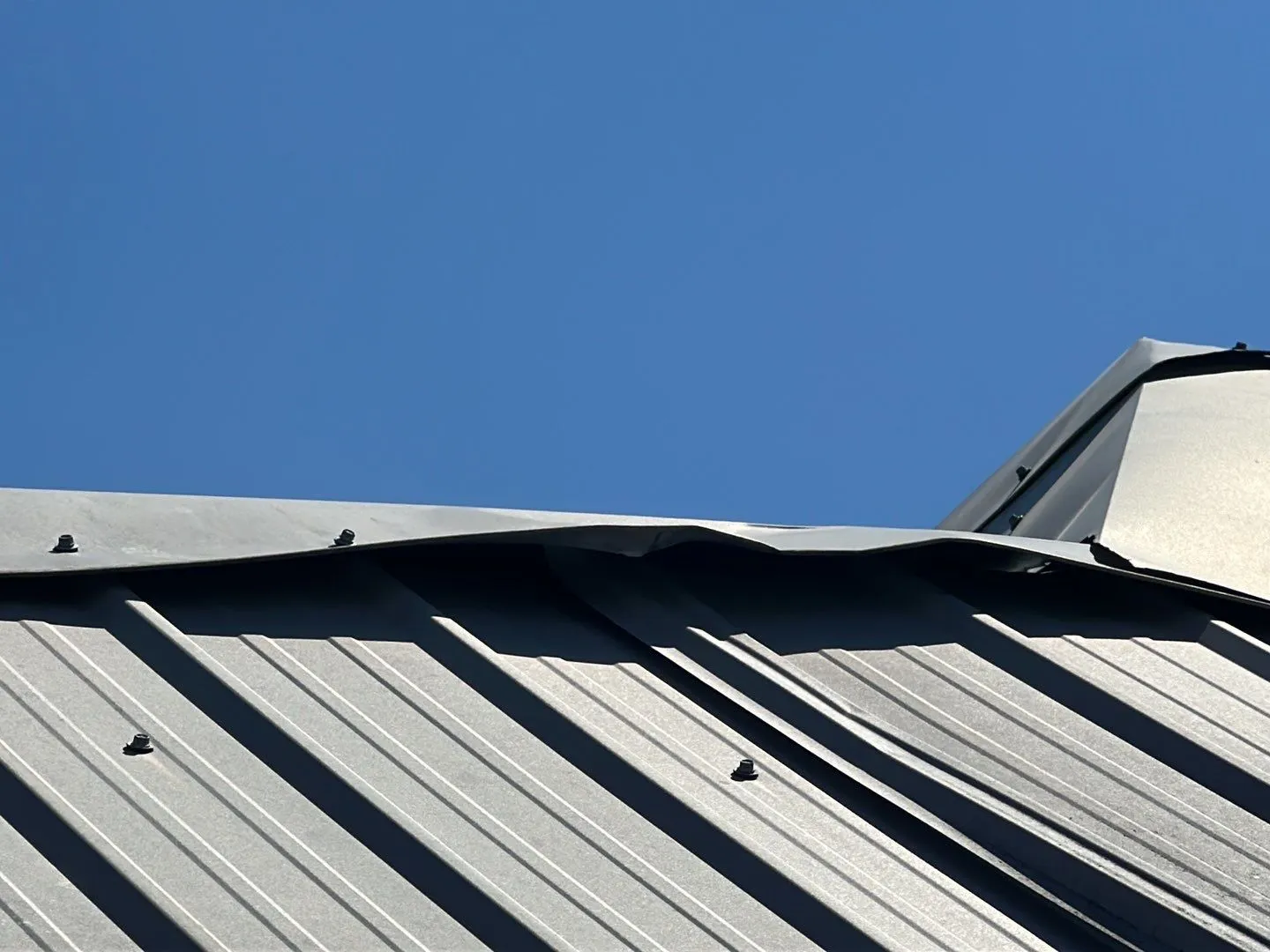 Metal roof with wind damage in Florence TX