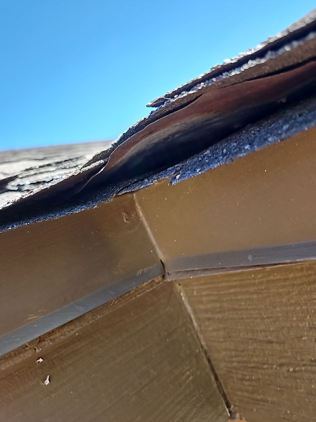 Wind damage on asphalt shingle roof in Texas