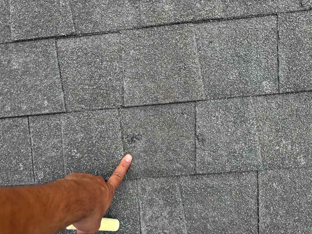 Inspecting-for-hail-damage-on-asphalt-shingles-in-River-Mountain-Rd-Wimberley-TX-78676-by-Legacy-Roofing-Pros