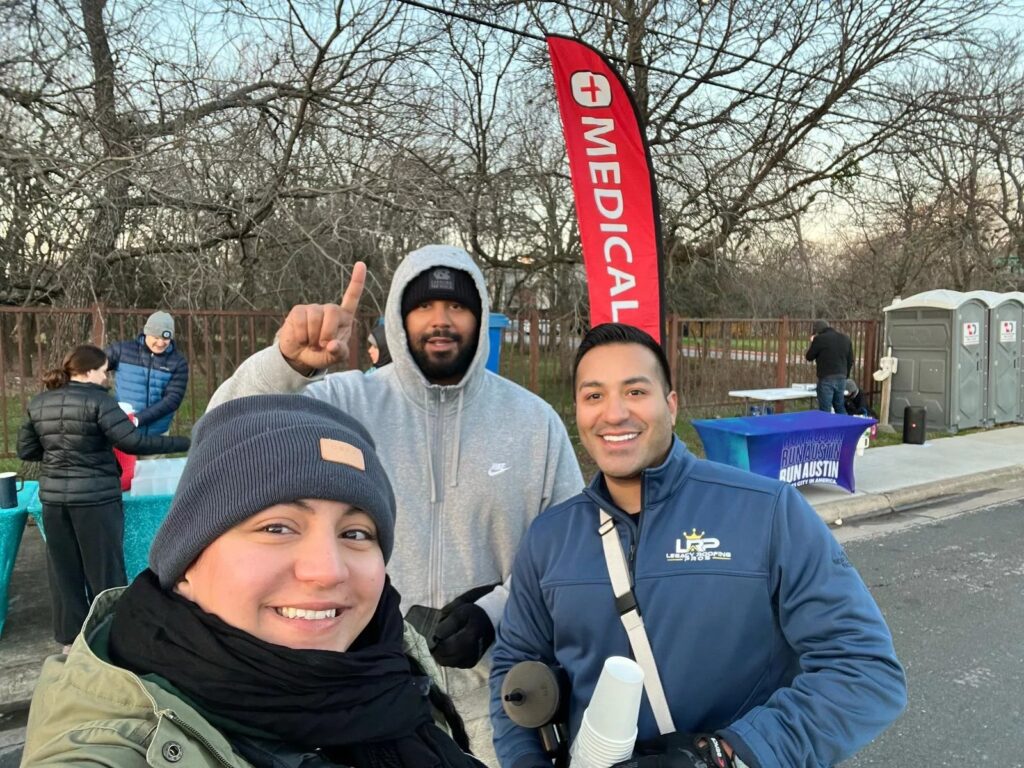 Legacy Roofing Pros volunteers supporting the Down Syndrome Association of Central Texas at the Austin Marathon 2025 hydration station