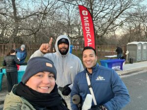 Legacy Roofing Pros volunteers supporting the Down Syndrome Association of Central Texas at the Austin Marathon 2025 hydration station