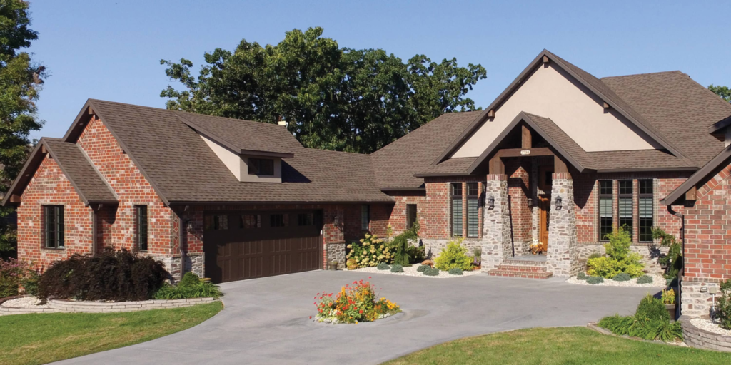 Brick home with TAMKO Titan XT architectural asphalt shingles installed on a durable residential roofing system.