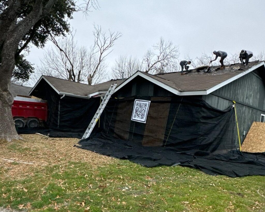catch-all roofing system with protective netting installed around home during roof replacement