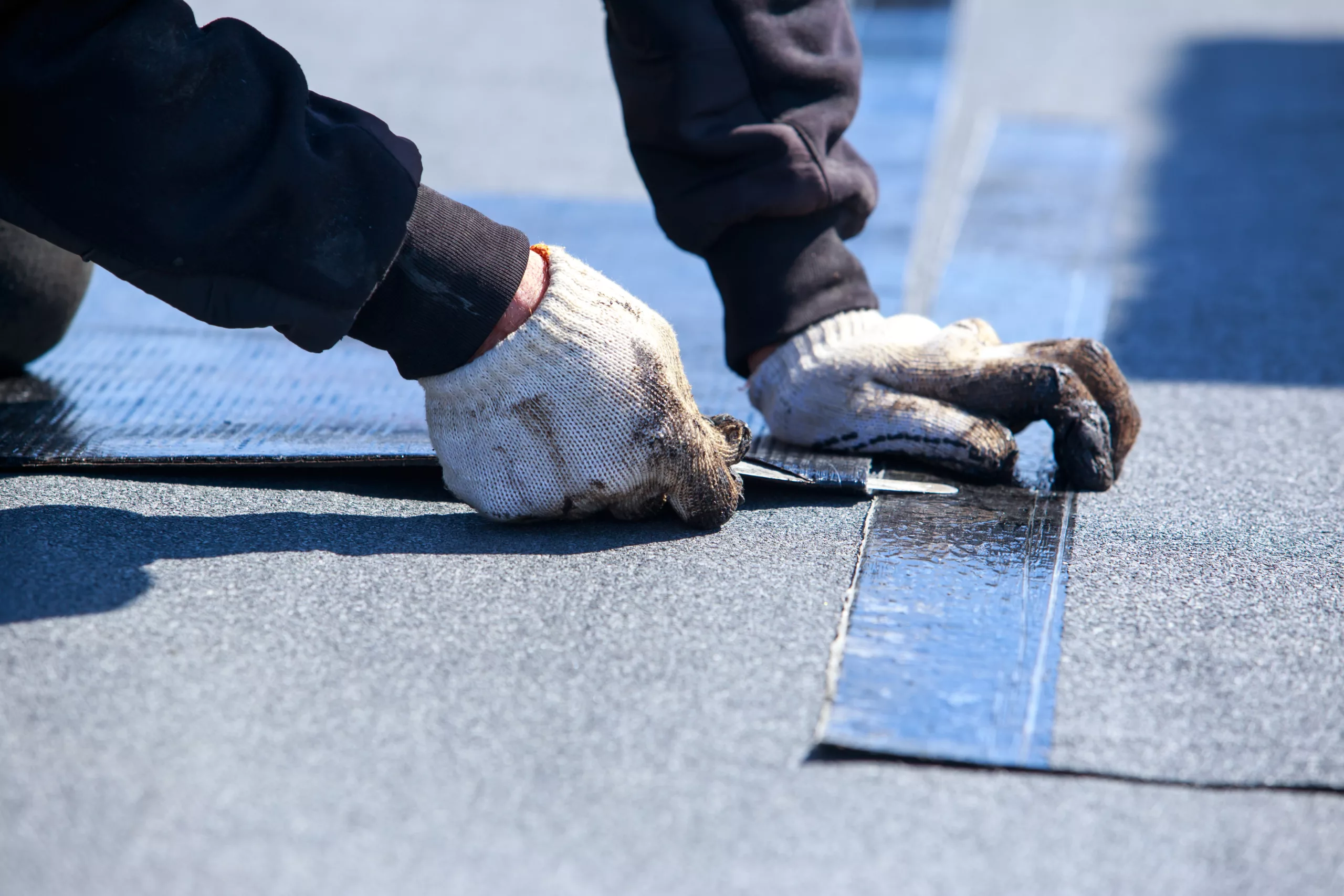 Roofer repairing a flat roof