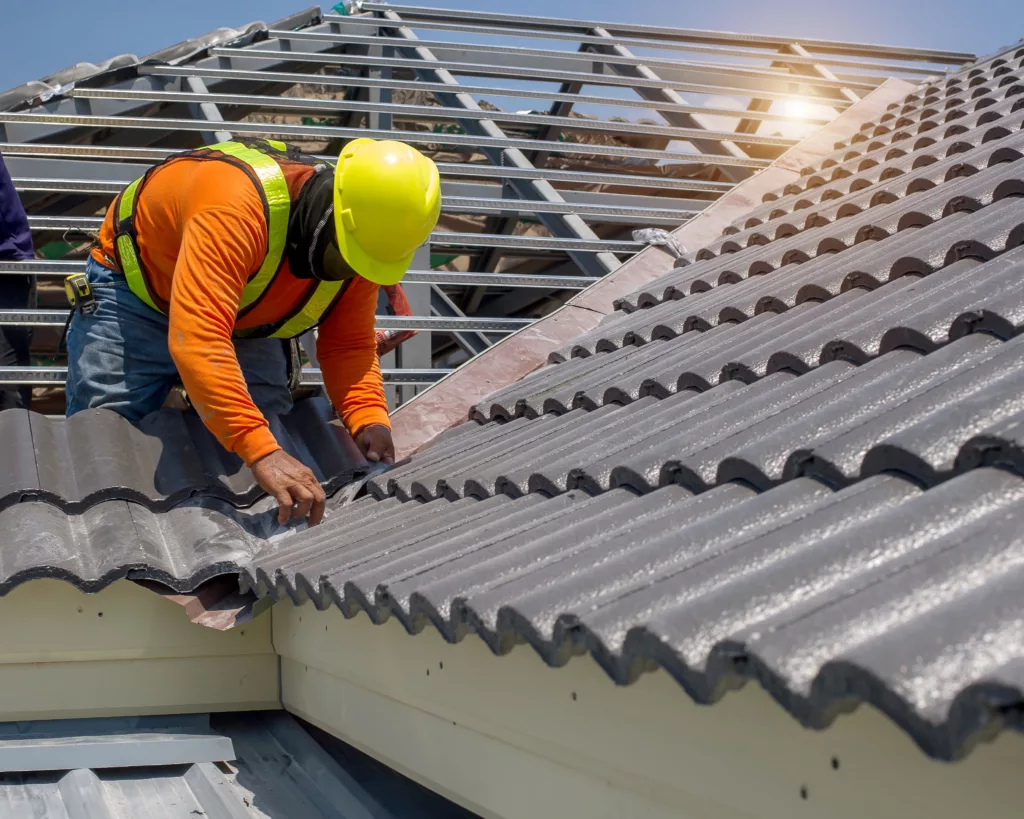Construction worker replacing tile roof