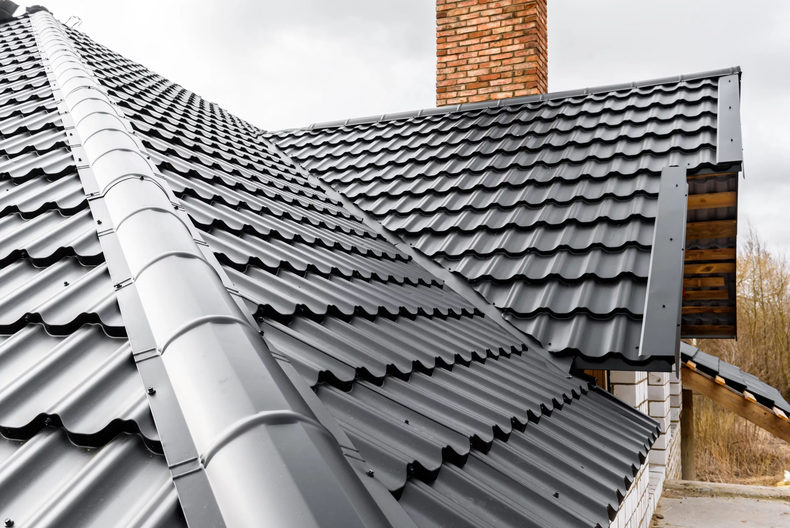 Metal roof on a brick building with a brick chimney