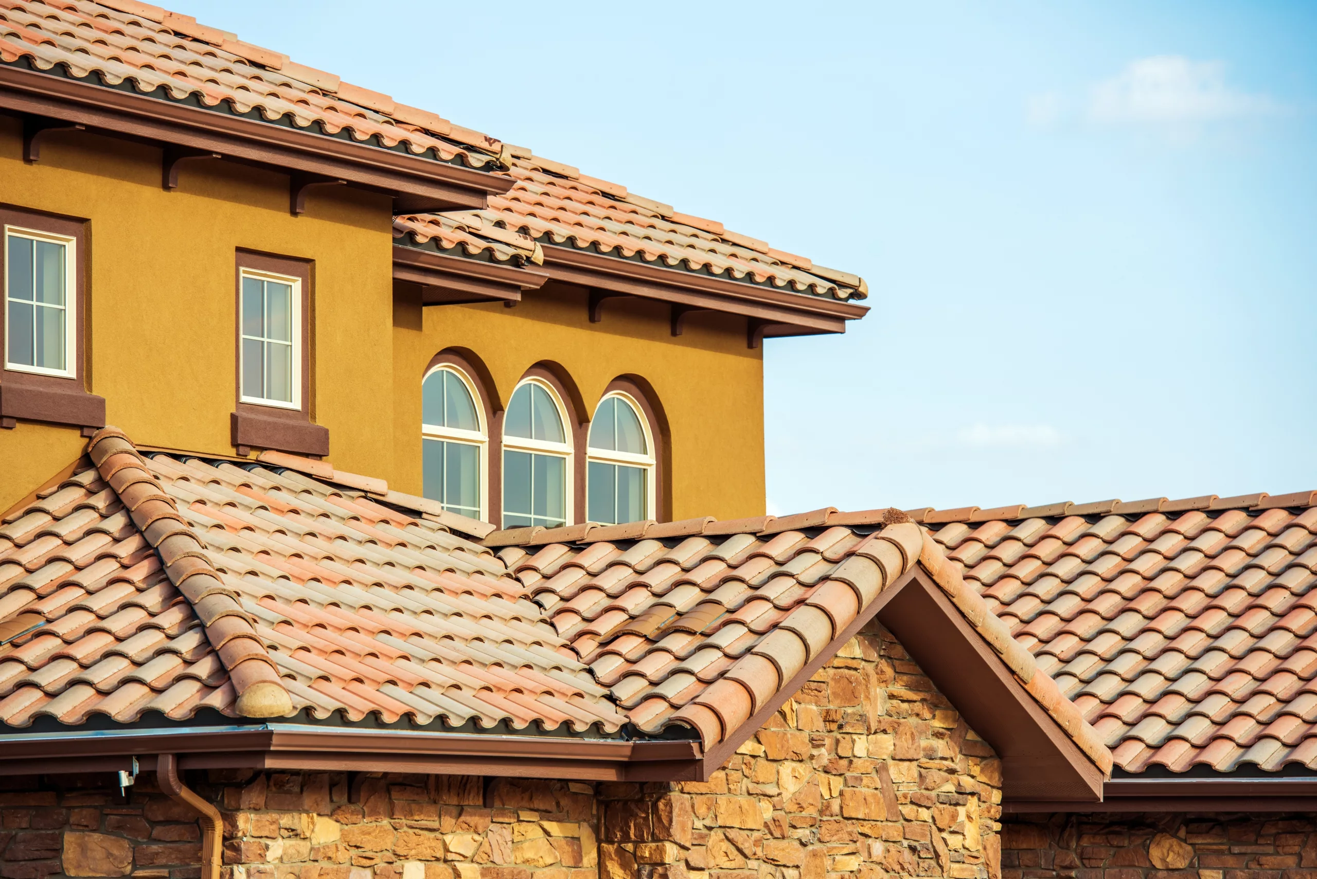 Tile roof on orange building with windows