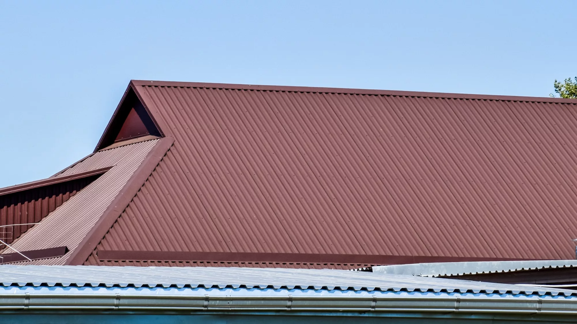 Home with dark red metal roofing