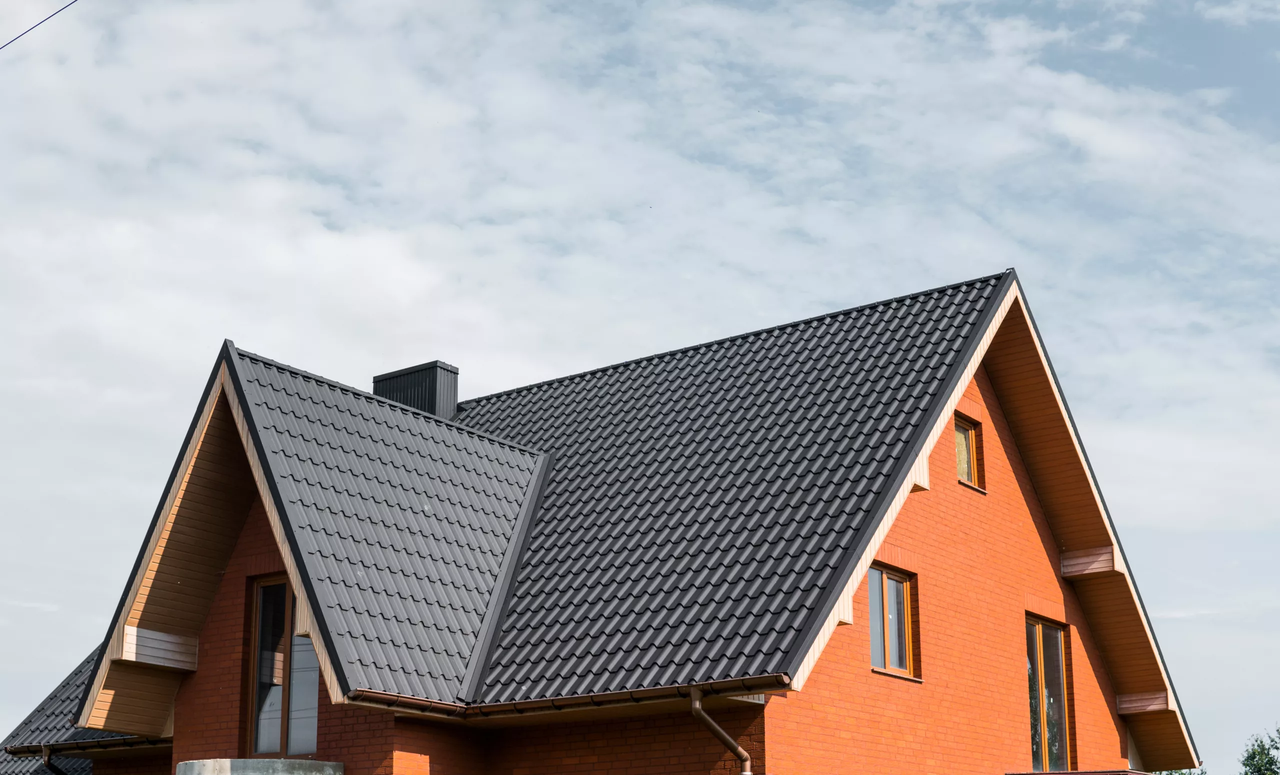 Green metal roof on a brick building