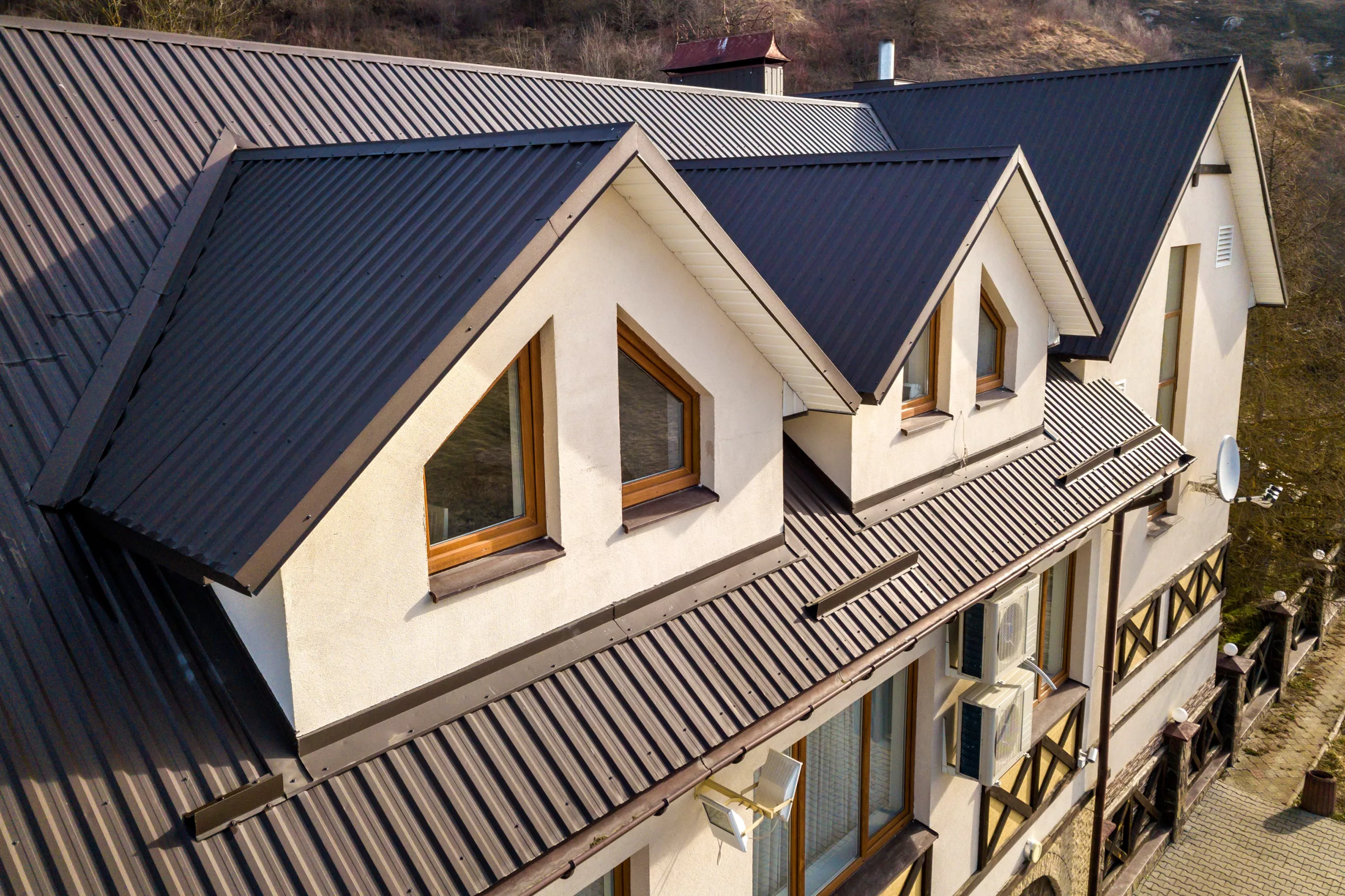 Brown metal roof on a stucco building