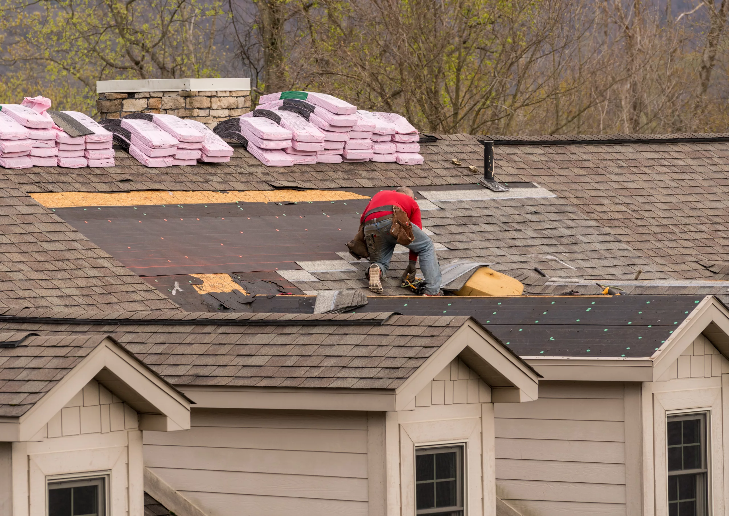 Workers installing a new roof on a house