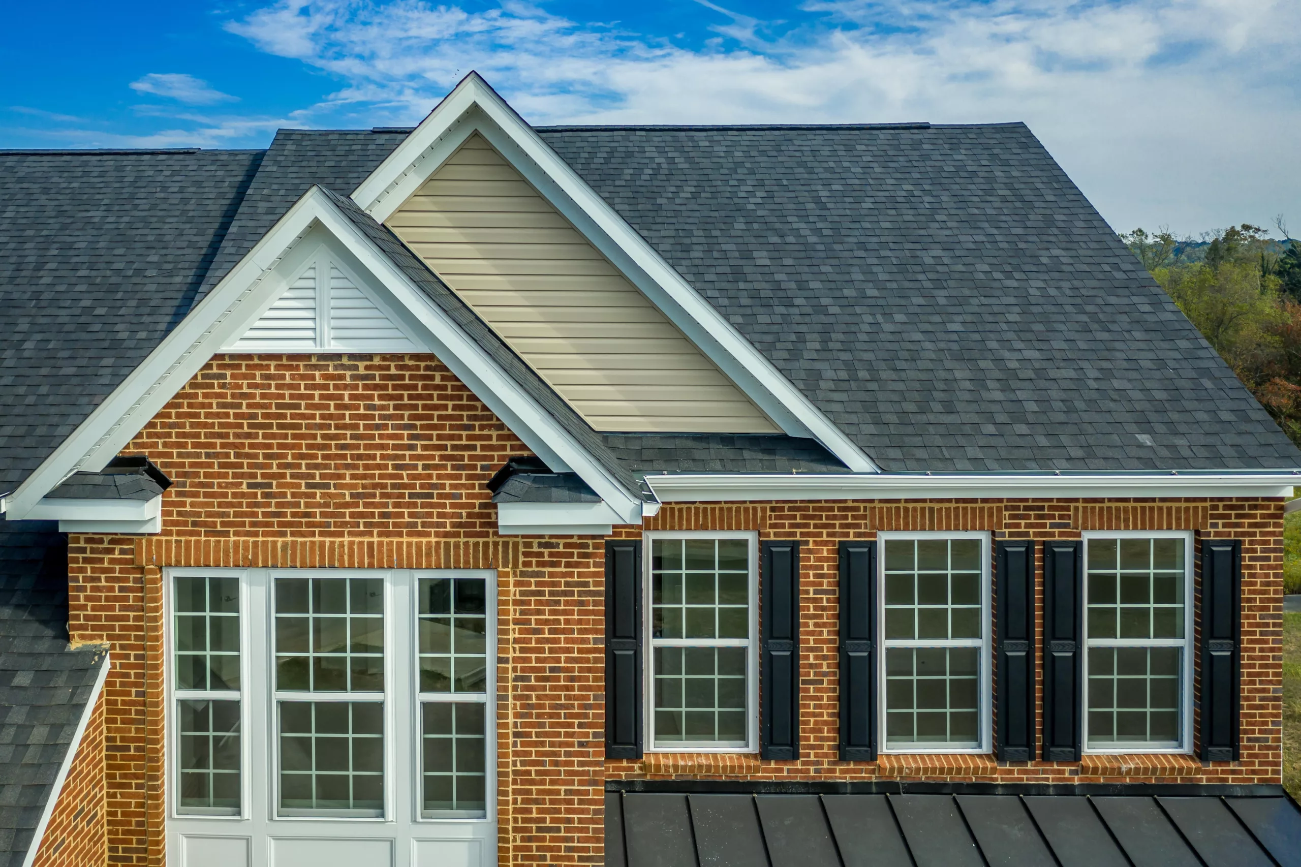 Asphalt shingle roof on a brick house