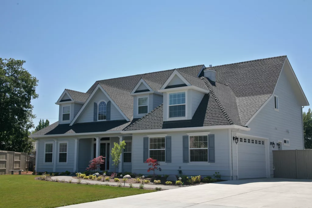Dark shingle roof on blue two-story house