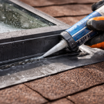 close up of skylight leak repair with sealant applied to flashing on residential roof in Texas
