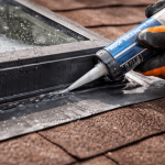 close up of skylight leak repair with sealant applied to flashing on residential roof in Texas