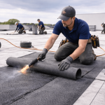 Commercial roof repair on a large flat roof by professional roofing contractors in Texas