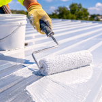 contractor applying protective metal roof coating to commercial metal roofing system in Texas