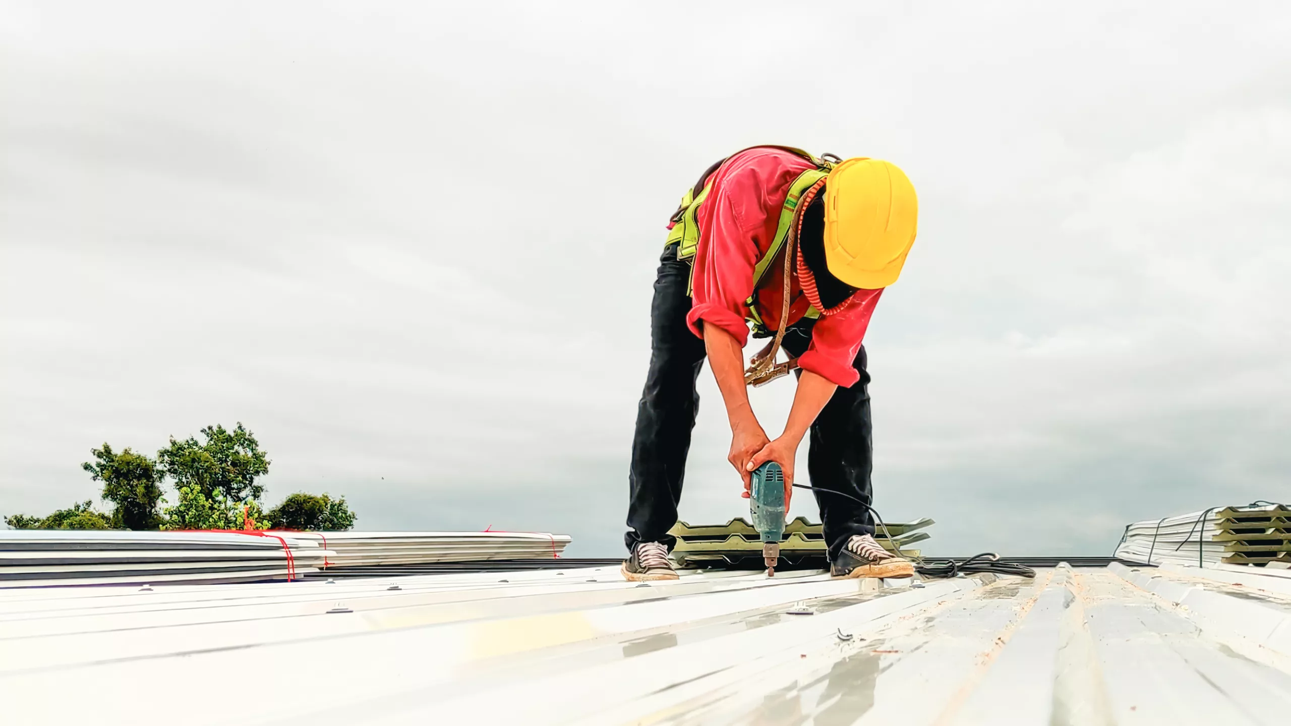 Worker replacing a commercial flat roof