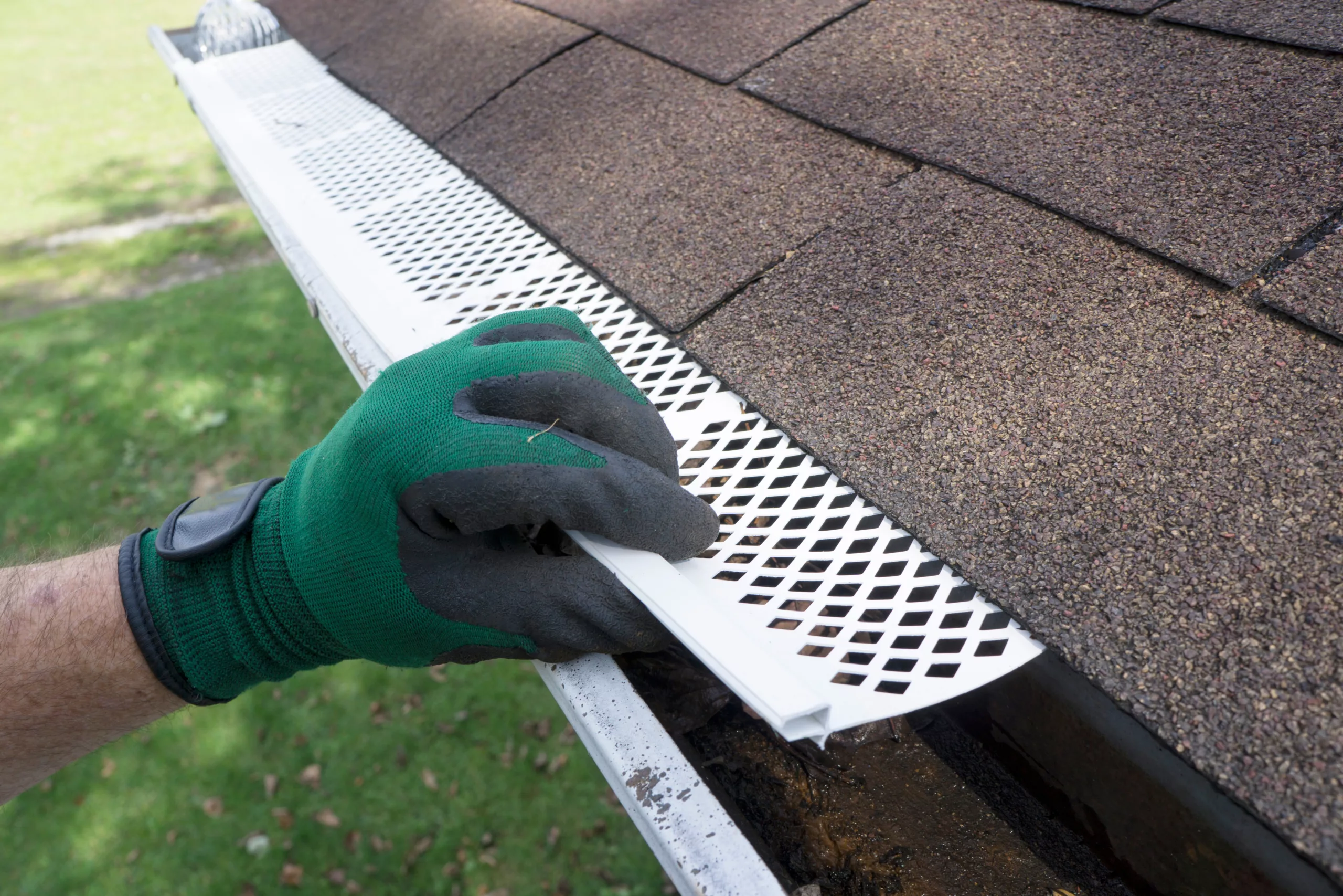 Hand installing gutter guard
