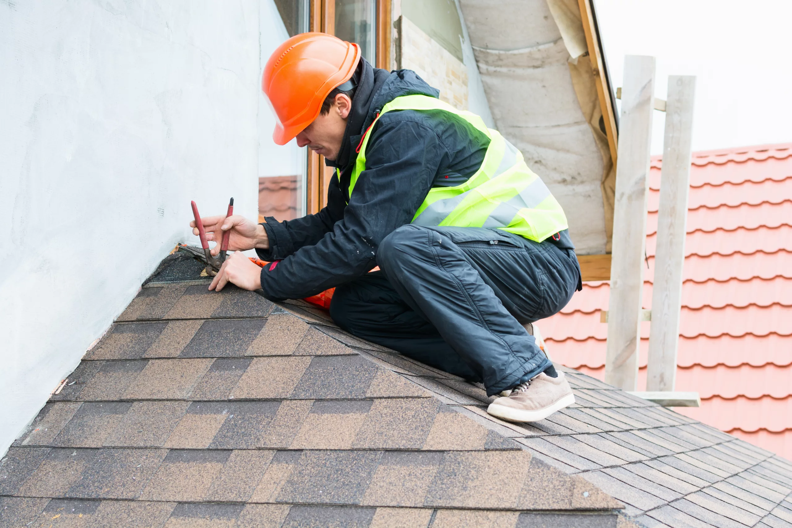 Worker repairing a residential roof