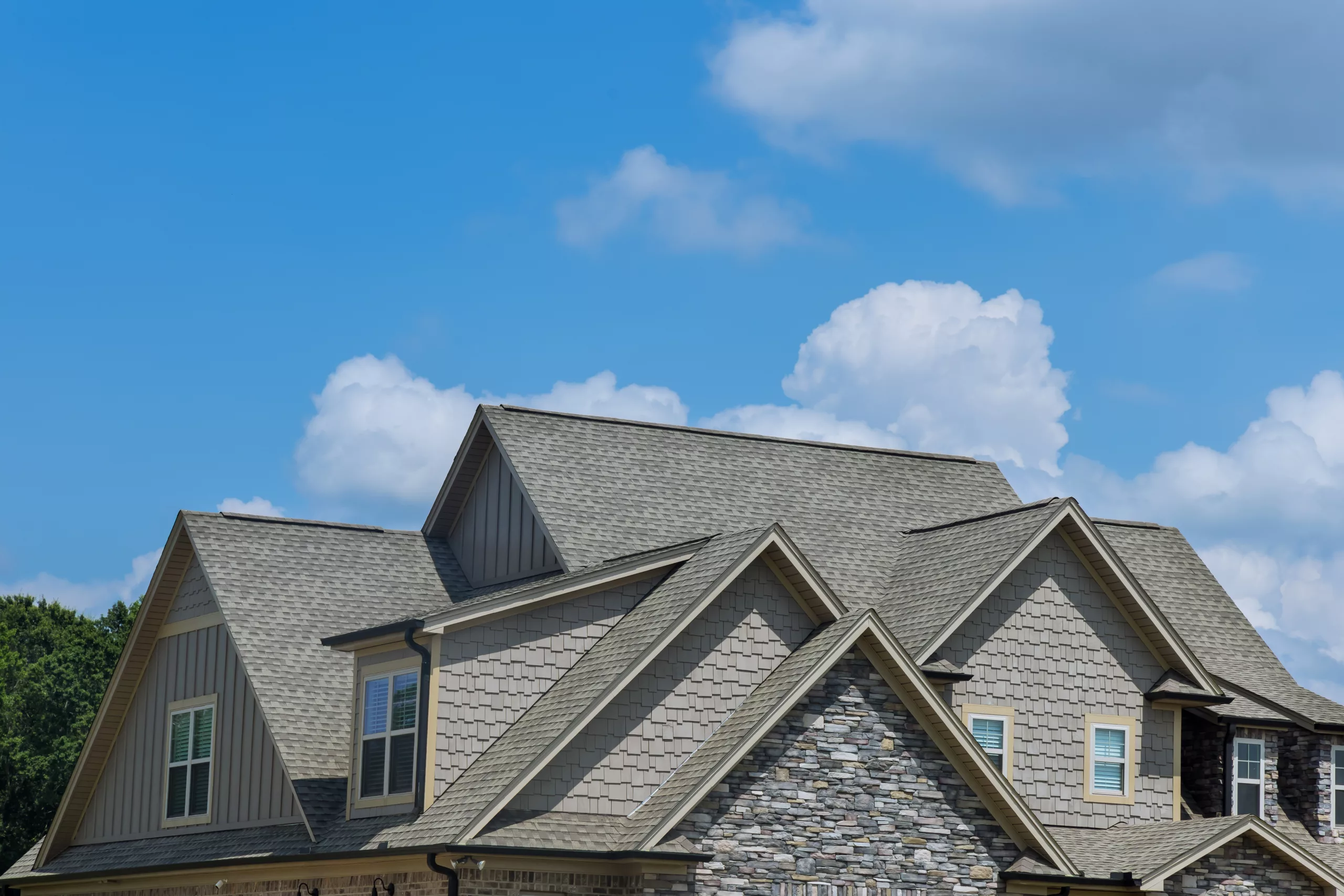 Asphalt shingle roof on a two-story house