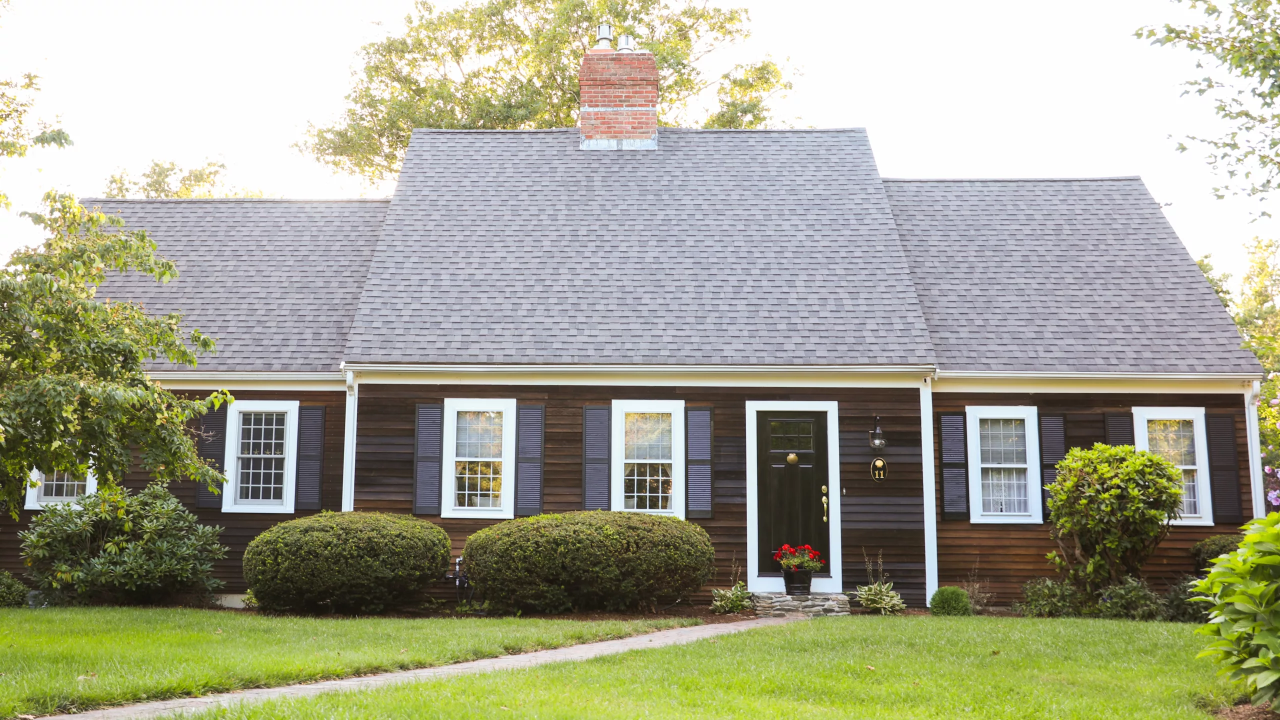 Beautiful home with large steep-sloped asphalt shingle roofing