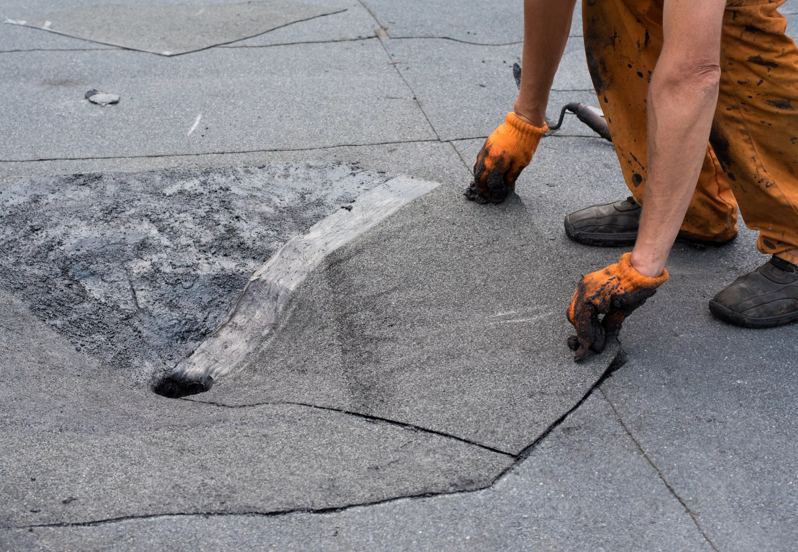 Roofer repairing a flat roof