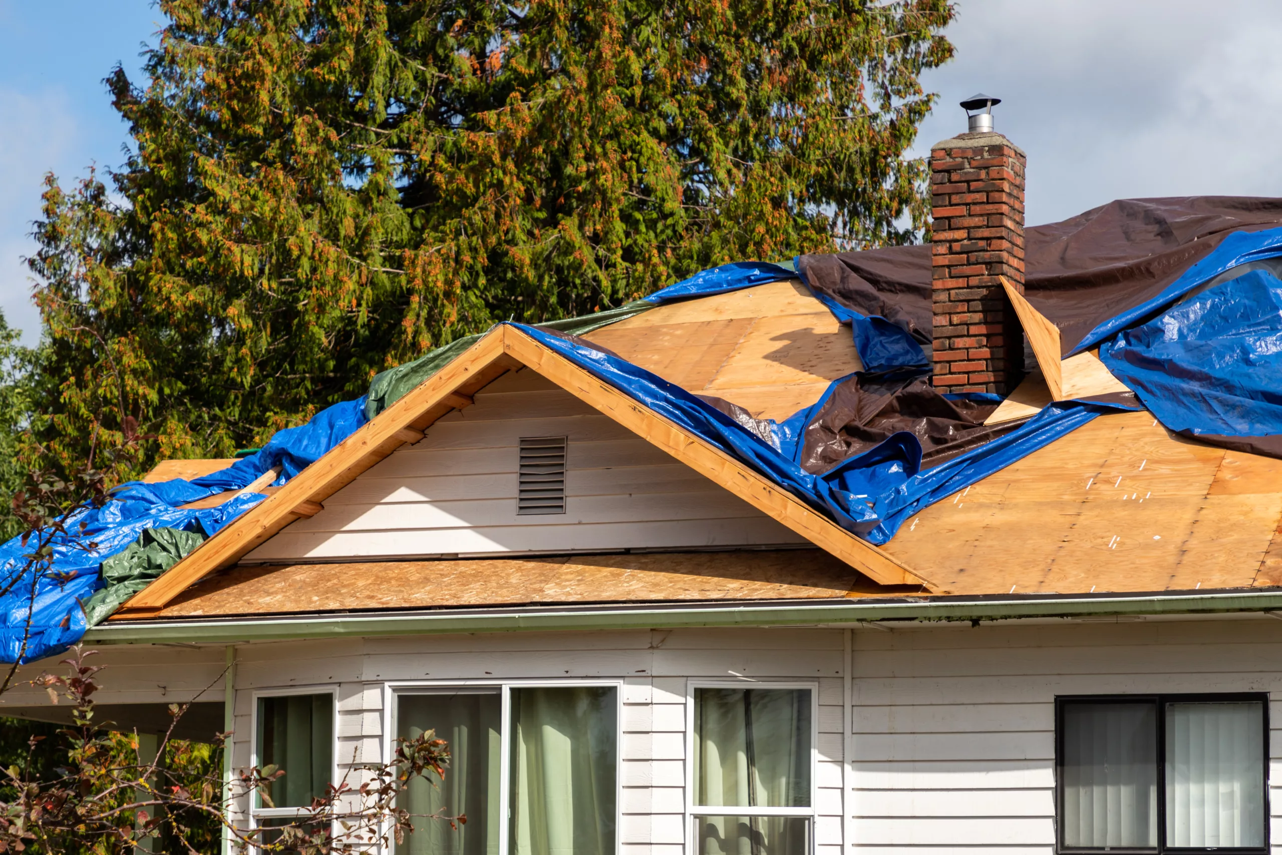 Roof damage to a house after a storm