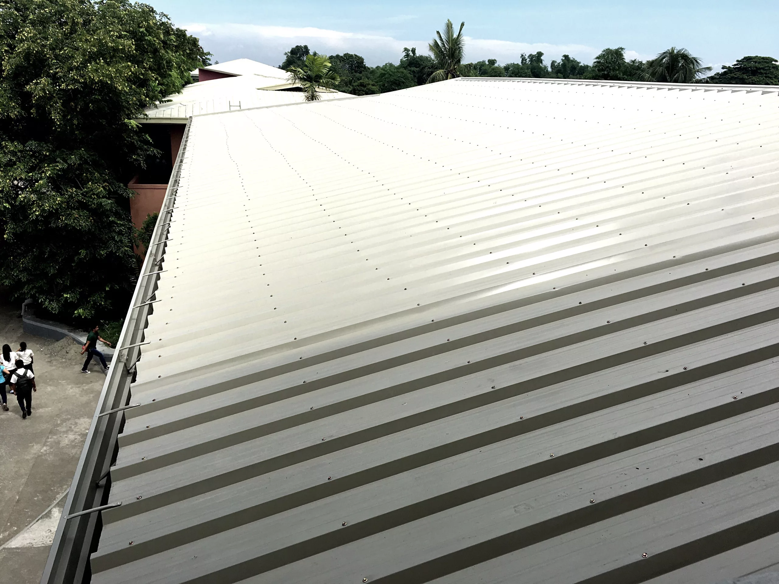 This photo shows a roofer on a commercial roof.