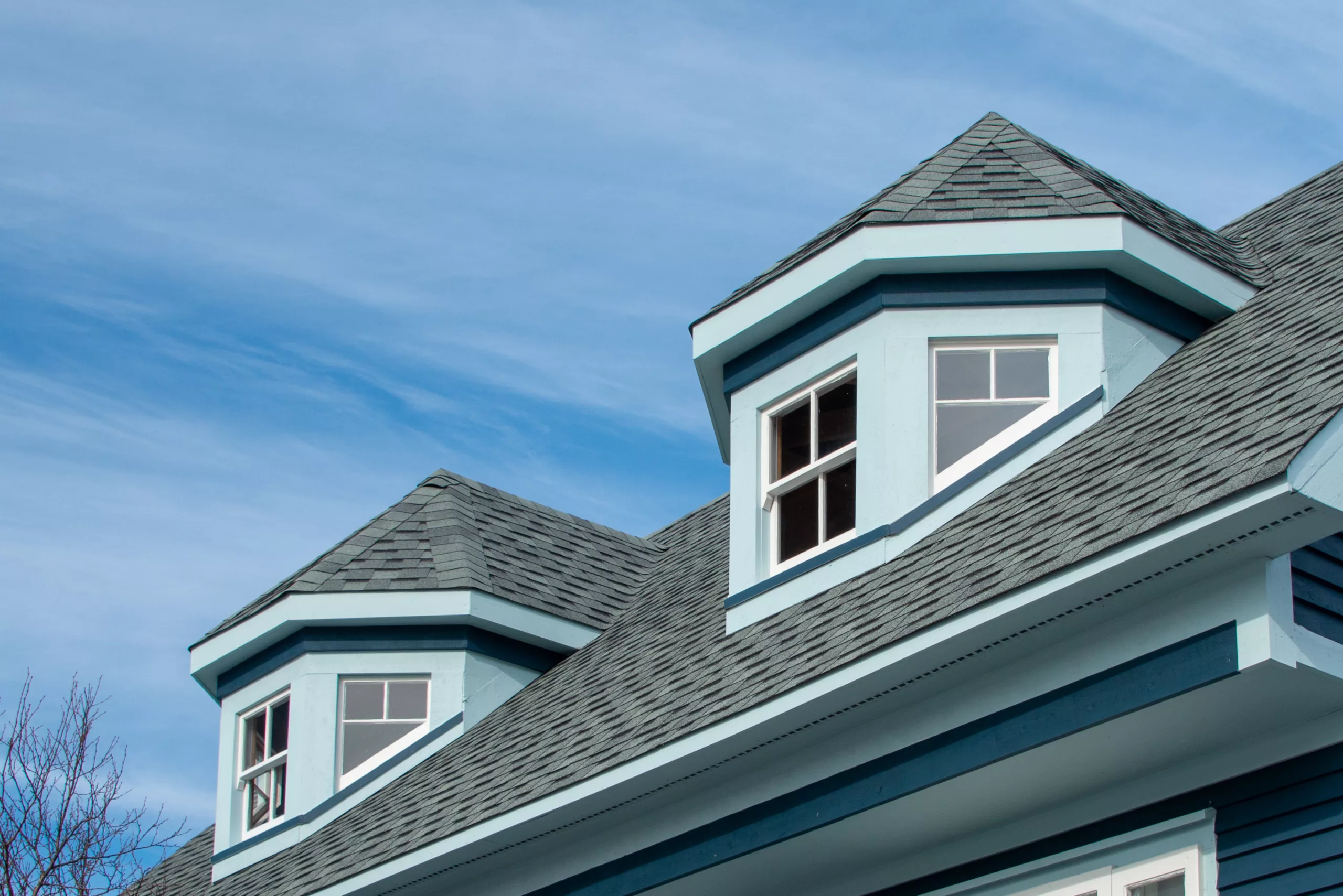 Asphalt single roof on a blue house