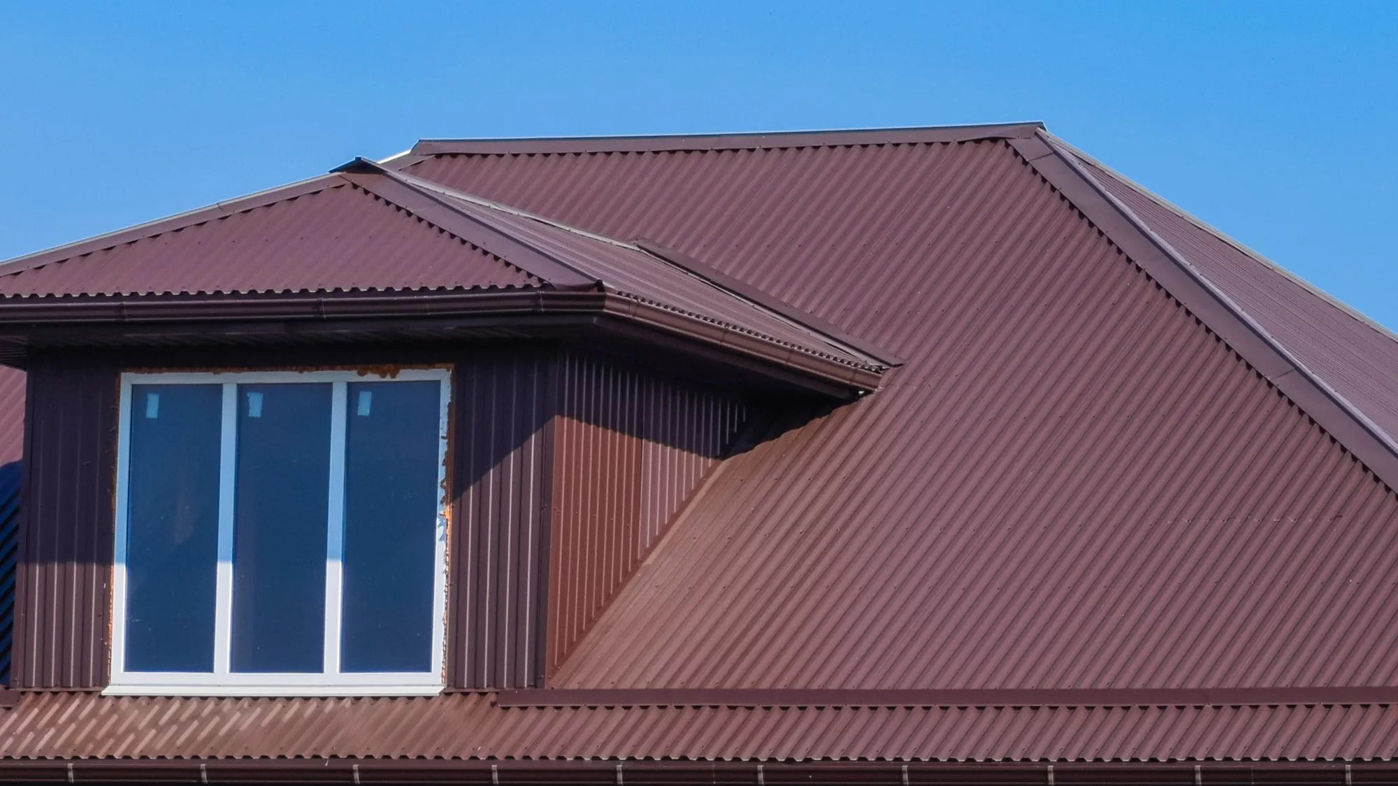 Home with dark red metal roofing