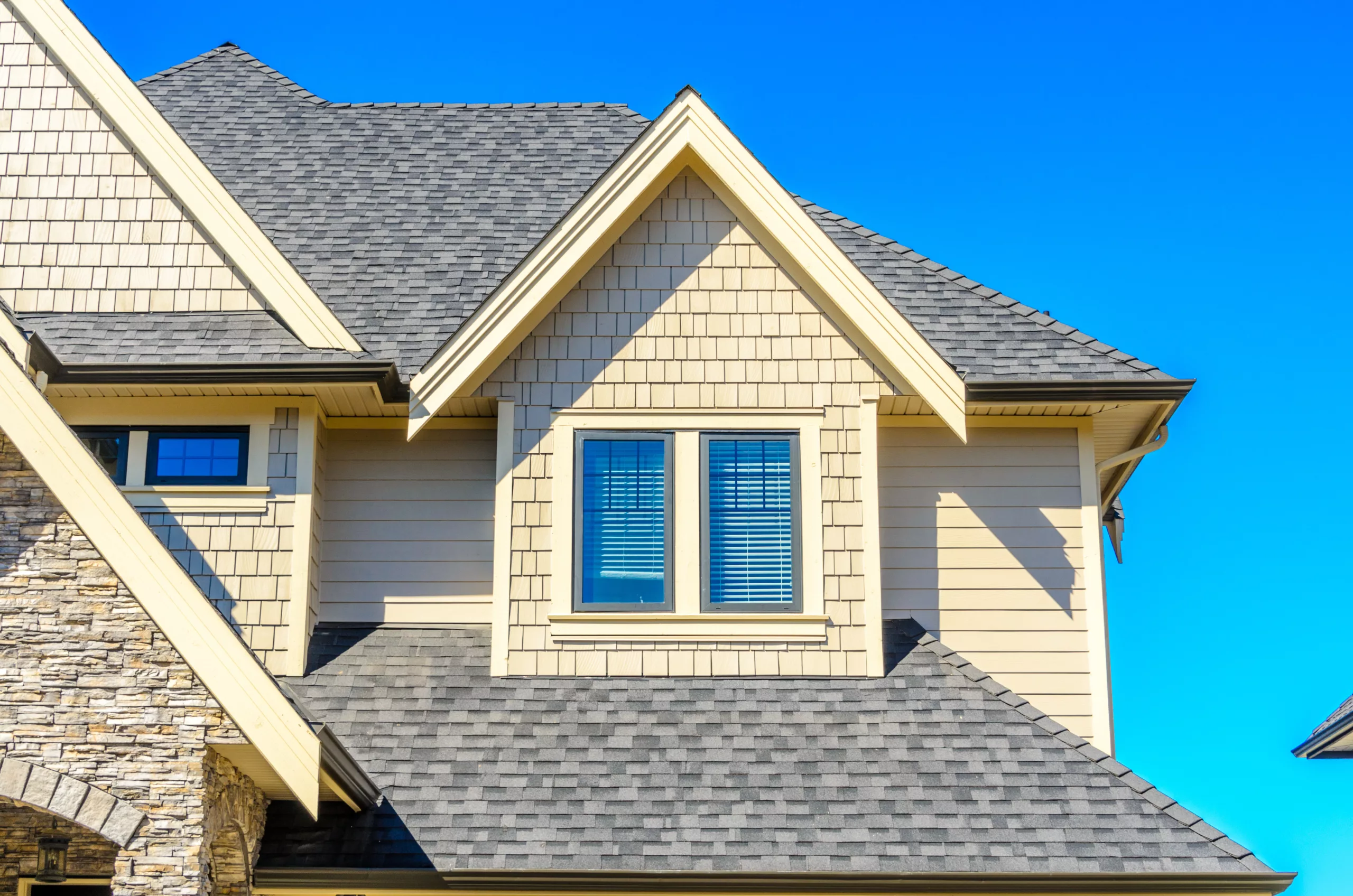 Asphalt shingles on a tan house