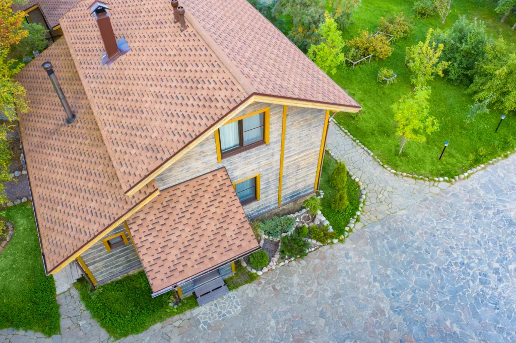 Aerial view of wood house with a detailed asphalt roof