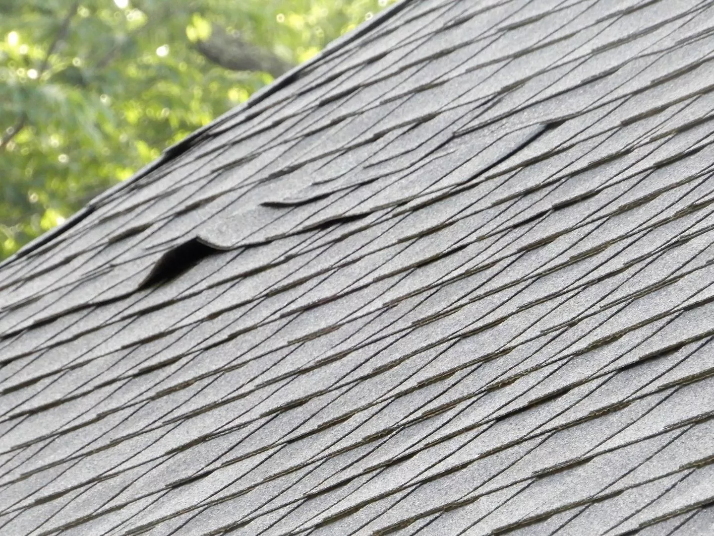 Close-up photo of shingles curling upward from heat exposure