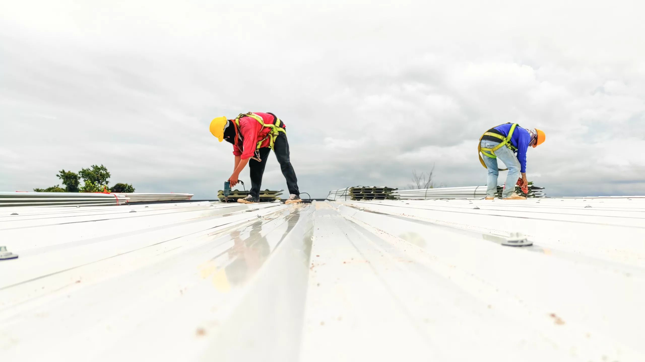 Worker replacing a commercial flat roof