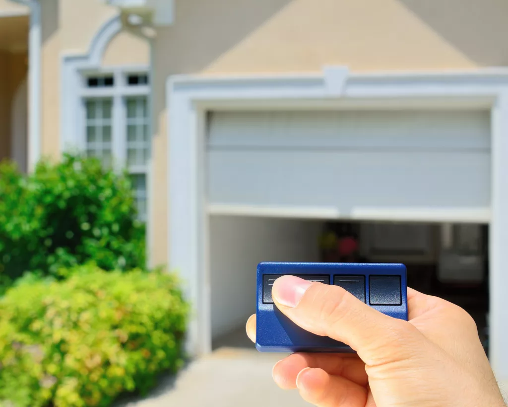 Homeowner pushing button to open garage door