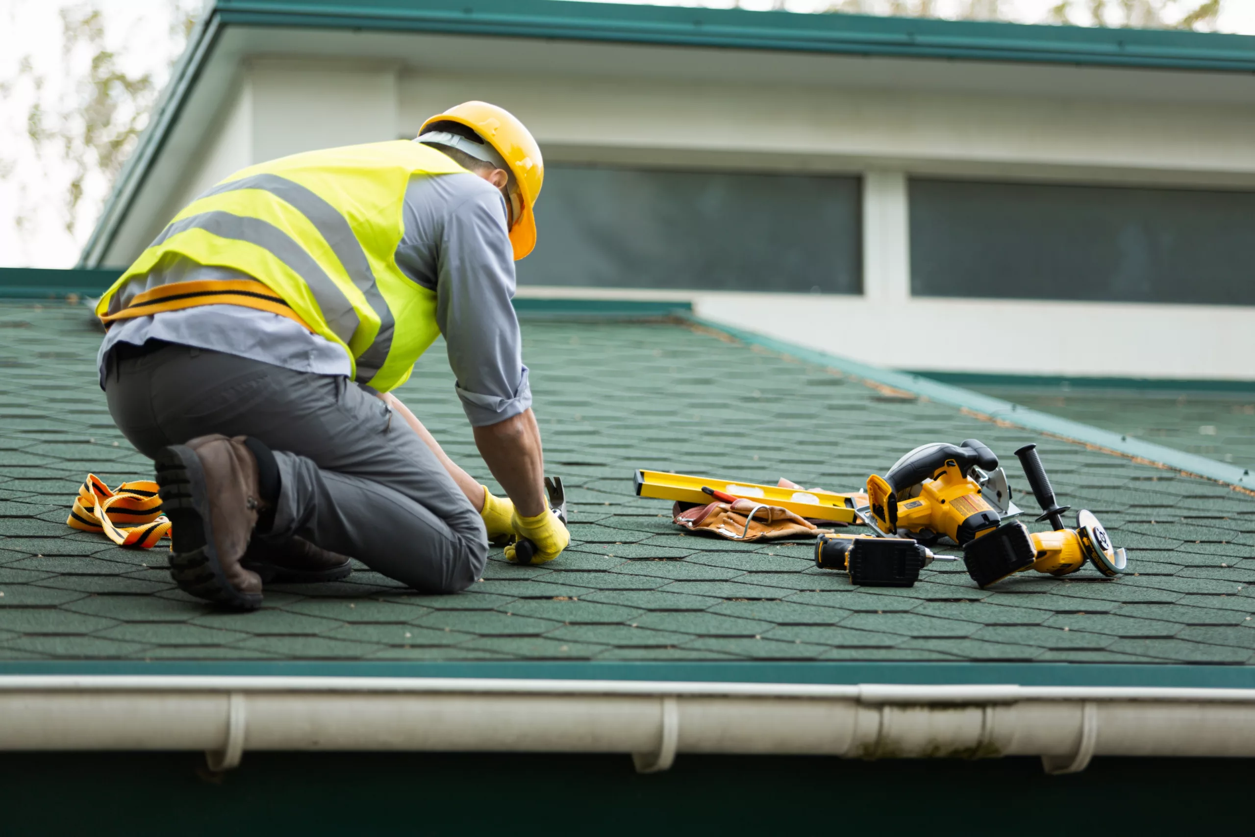 This photo shows a close-up of a roofer repairing a damaged roof.